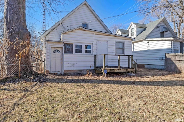 rear view of house featuring a yard