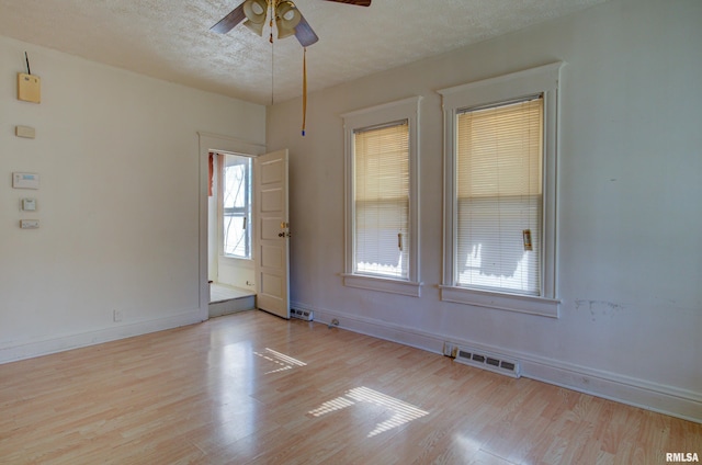 spare room featuring ceiling fan, a textured ceiling, and light hardwood / wood-style floors