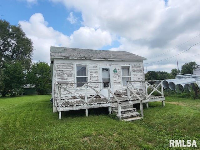 back of property with a yard