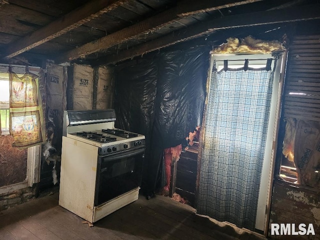 kitchen with dark wood-type flooring and white gas range oven