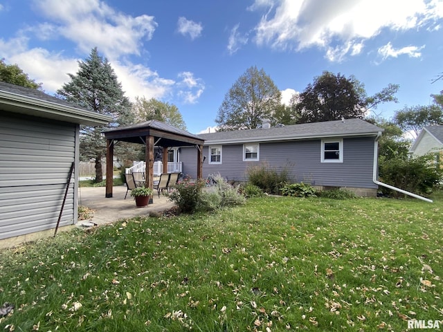 back of house with a gazebo, a yard, and a patio