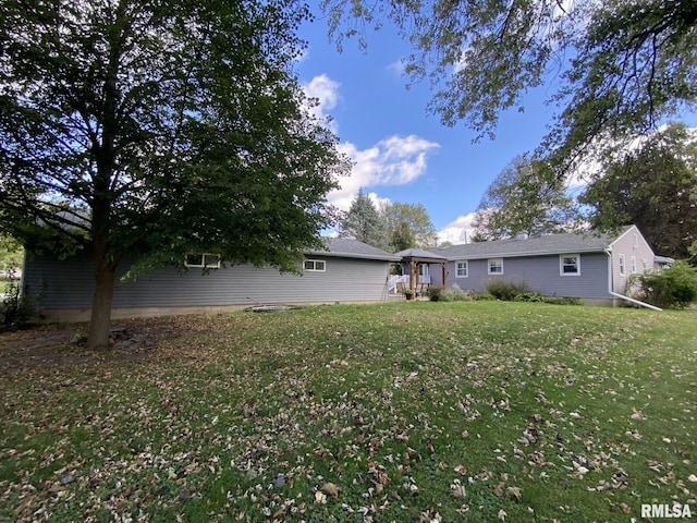 rear view of house with a lawn and a gazebo