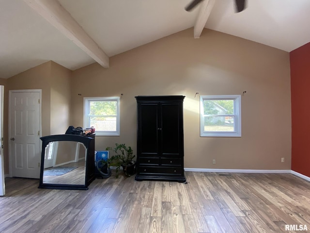 exercise room with vaulted ceiling and hardwood / wood-style floors