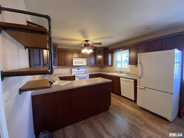 kitchen with white appliances, hardwood / wood-style floors, sink, kitchen peninsula, and ceiling fan