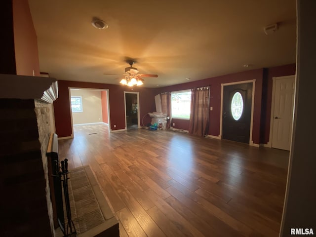 interior space featuring ceiling fan, hardwood / wood-style floors, and a fireplace