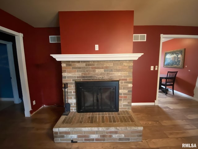 room details featuring a fireplace and hardwood / wood-style flooring