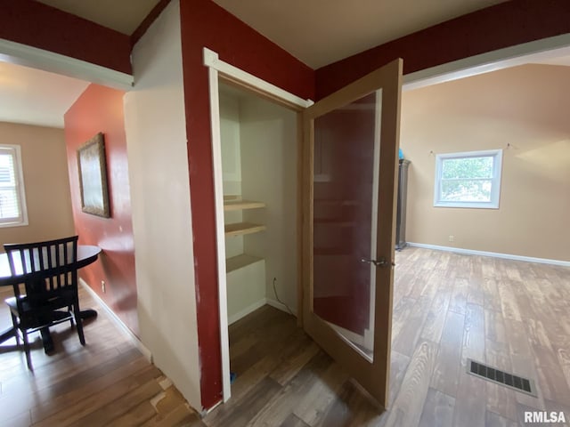 corridor with wood-type flooring