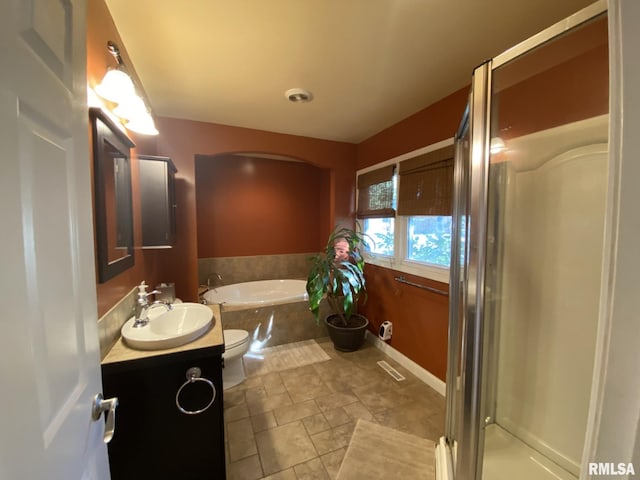 full bathroom with toilet, vanity, and separate shower and tub