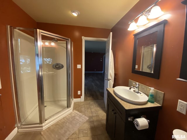 bathroom featuring walk in shower and vanity