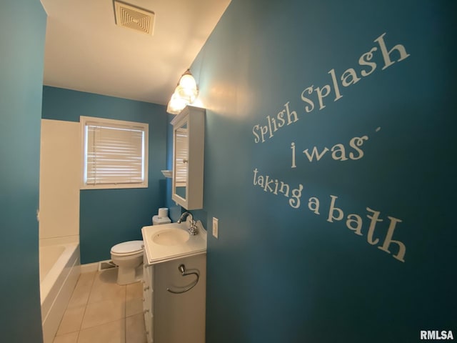 bathroom with toilet, vanity, tile patterned flooring, and a bathing tub