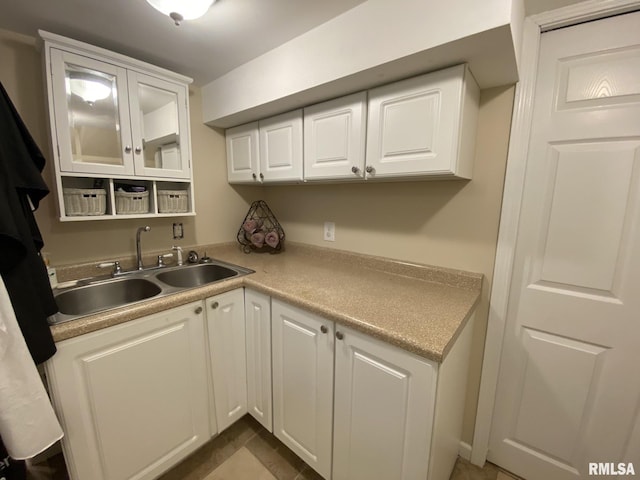 kitchen featuring white cabinets and sink