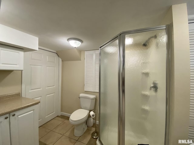 bathroom with toilet, walk in shower, tile patterned floors, and vanity