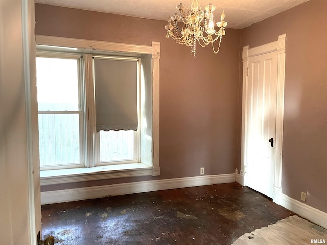 spare room with a notable chandelier