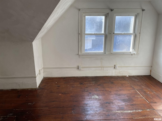 additional living space featuring dark hardwood / wood-style floors, a wealth of natural light, and lofted ceiling