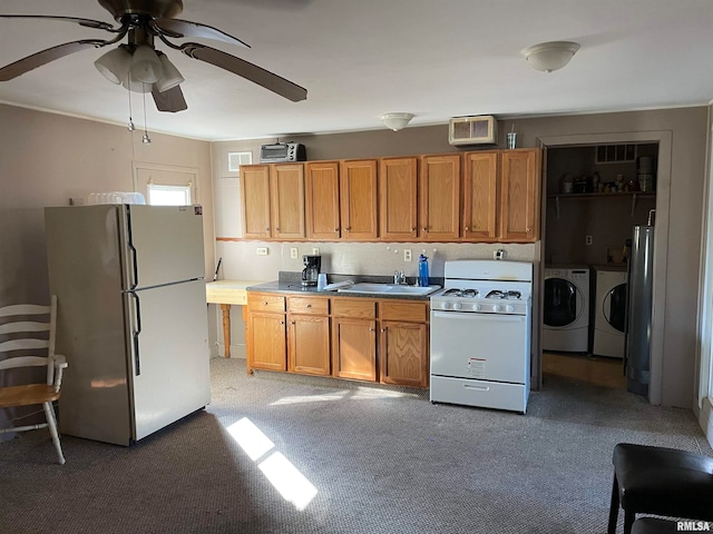 kitchen featuring independent washer and dryer, ceiling fan, white gas stove, fridge, and dark carpet