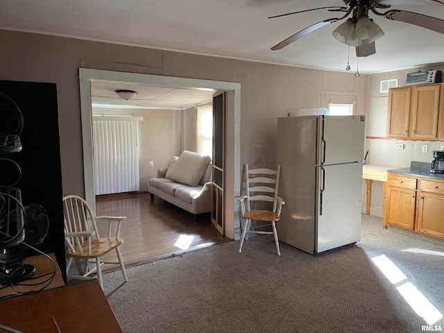 kitchen with stainless steel fridge, ceiling fan, and carpet floors