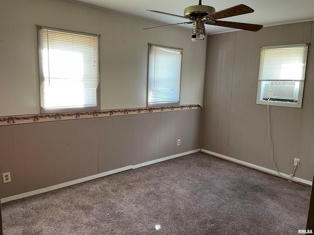 carpeted empty room with plenty of natural light and ceiling fan