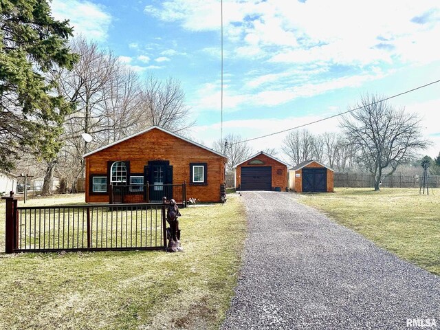 view of front of home featuring a front yard, a garage, an outdoor structure, and a wooden deck