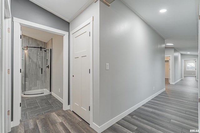 hallway with vaulted ceiling, dark hardwood / wood-style floors, and crown molding