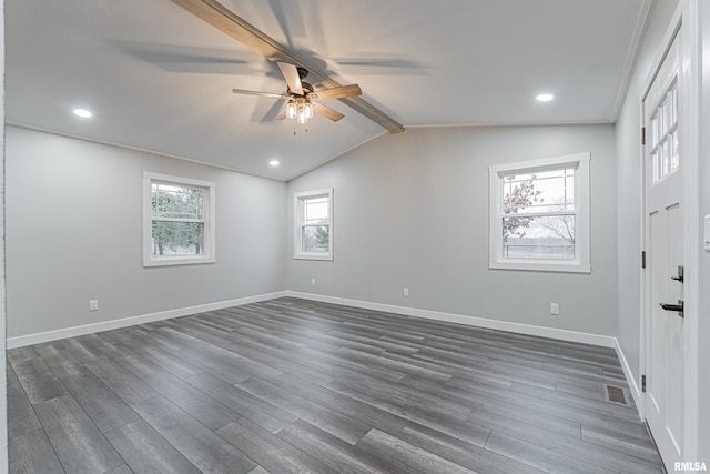 empty room featuring ceiling fan, dark hardwood / wood-style flooring, and lofted ceiling with beams