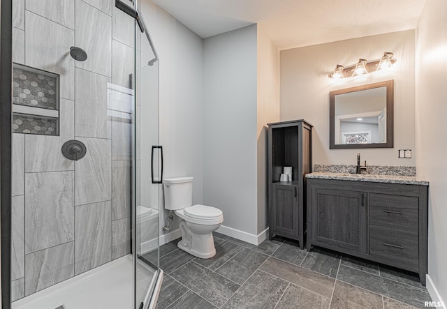 bathroom with a shower with door, vanity, and toilet