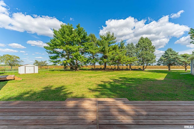 view of yard featuring a storage shed and a deck