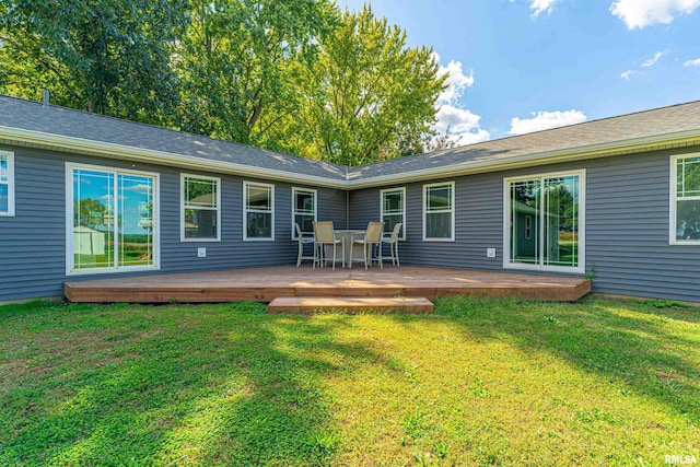 rear view of property featuring a wooden deck and a yard