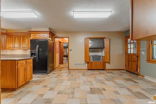 kitchen featuring black fridge with ice dispenser