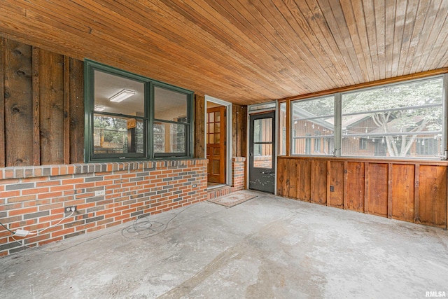 unfurnished sunroom with wooden ceiling