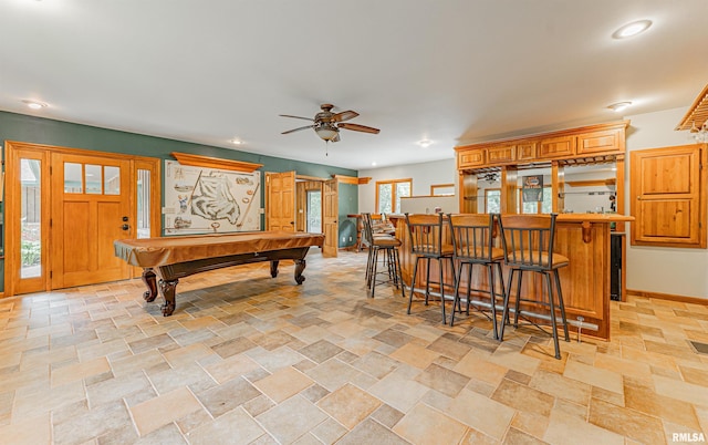 rec room with ceiling fan, a wealth of natural light, pool table, and bar