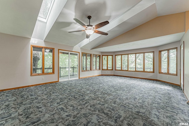 interior space with lofted ceiling with skylight, carpet flooring, and a healthy amount of sunlight