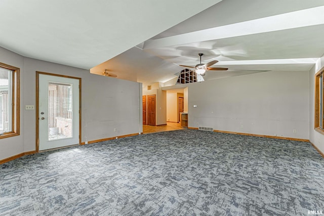 unfurnished living room featuring ceiling fan, carpet flooring, and vaulted ceiling