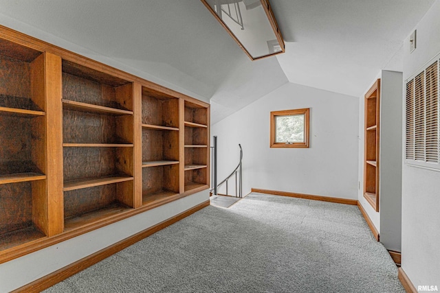 additional living space with built in shelves, carpet flooring, and lofted ceiling