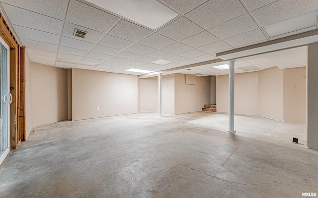 basement with a paneled ceiling