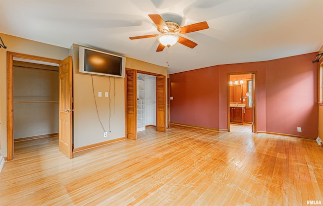 unfurnished bedroom with light hardwood / wood-style flooring, ensuite bath, and ceiling fan