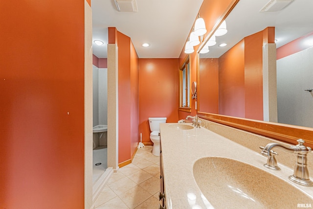 bathroom with vanity, toilet, and tile patterned floors