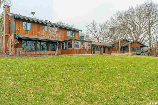 back of house featuring a sunroom and a yard