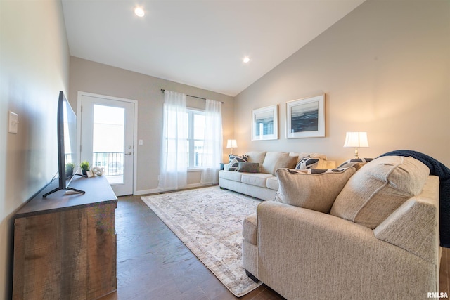 living room with dark wood-type flooring and high vaulted ceiling