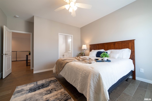 bedroom with ceiling fan, dark hardwood / wood-style floors, and ensuite bath