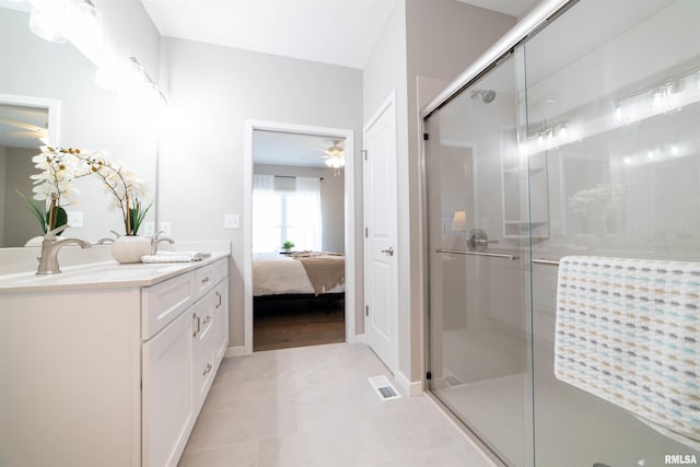 bathroom featuring vanity, ceiling fan, an enclosed shower, and tile patterned floors