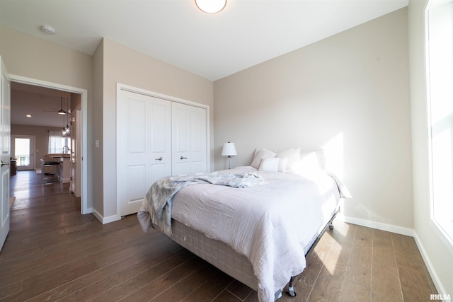 bedroom with dark wood-type flooring and a closet