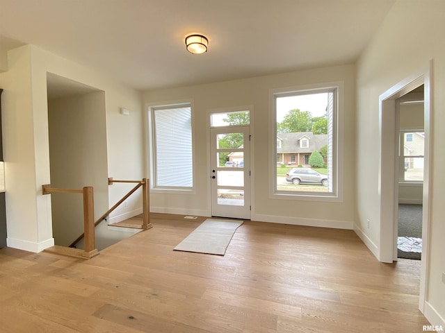 doorway featuring wood finished floors and baseboards