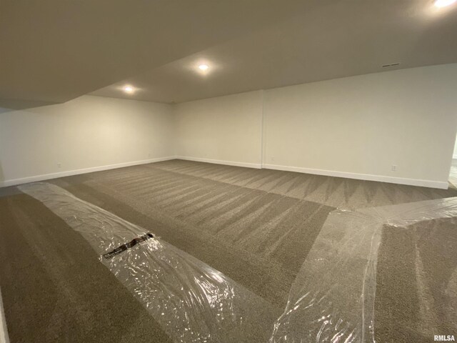 spare room with baseboards, dark colored carpet, and recessed lighting