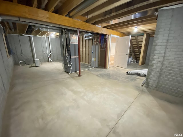 unfinished basement featuring gas water heater and heating unit