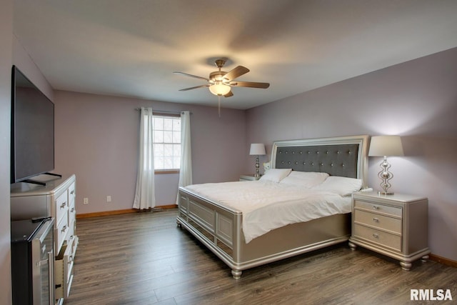 bedroom with dark hardwood / wood-style flooring and ceiling fan