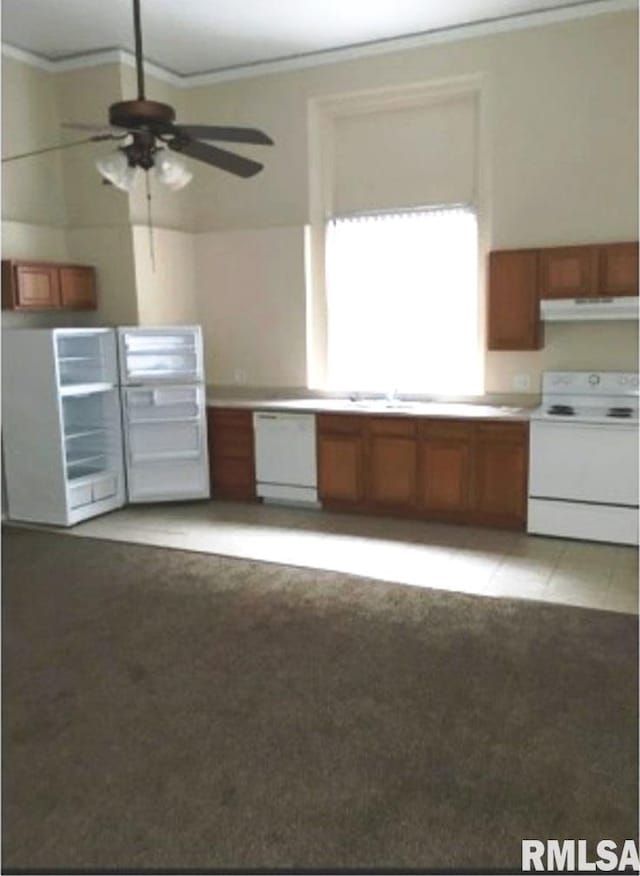 kitchen with white appliances, ceiling fan, ornamental molding, and light carpet