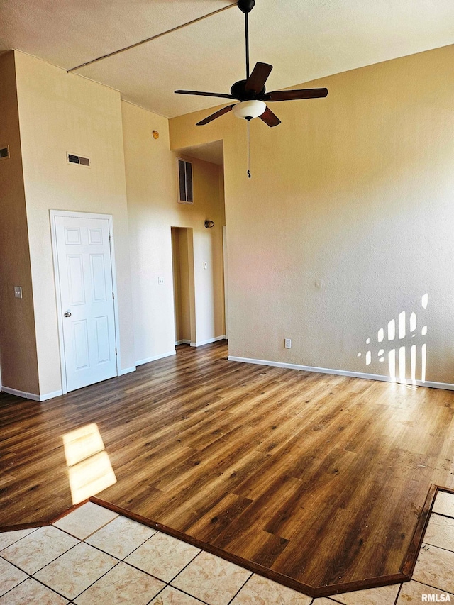 spare room featuring ceiling fan, light hardwood / wood-style flooring, and high vaulted ceiling