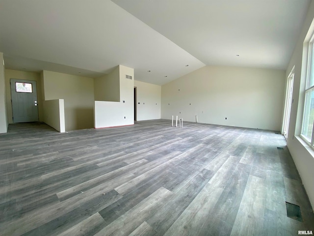 unfurnished living room featuring vaulted ceiling and hardwood / wood-style flooring