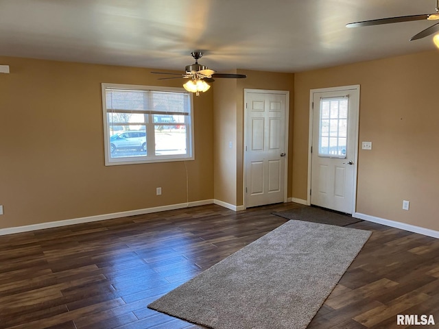 foyer with ceiling fan and dark hardwood / wood-style flooring