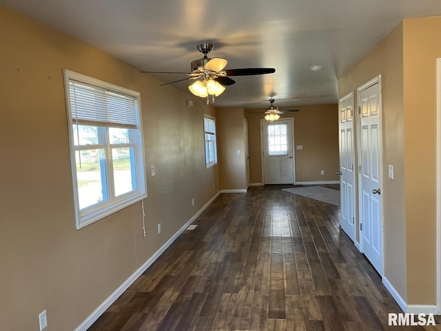 interior space with ceiling fan and dark hardwood / wood-style flooring